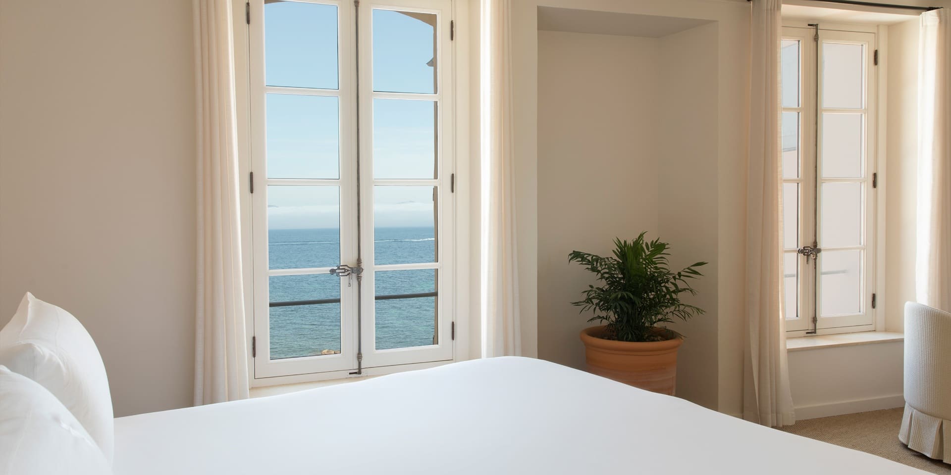 Deluxe Sea View Room, a window opening onto the La Ponche cove.